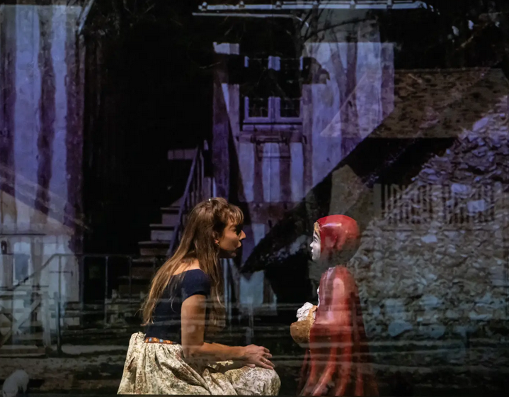 femme accroupie devant le petit chaperon rouge